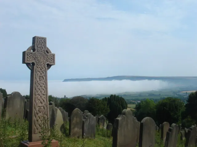 Graveyard of St. Stephen's church and mist over Robin Hood's Bay.