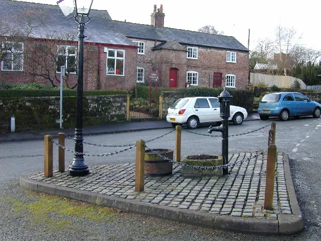 Great Barrow village hall, pump in the foreground.