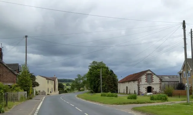 Houses and a barn at the east end of Helperthorpe village