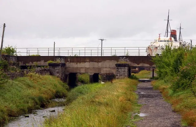 The railway crosses a stream and footpath