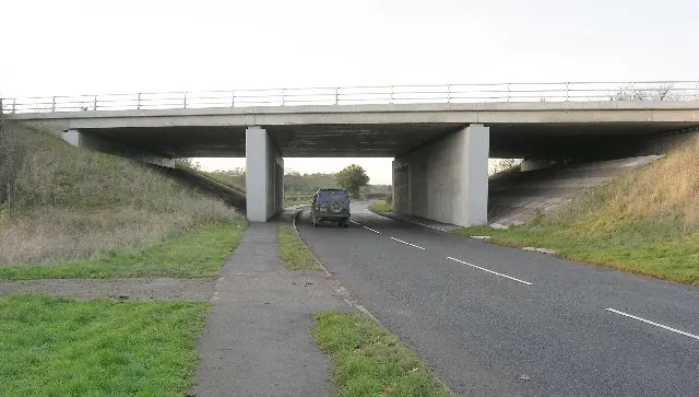 The A66(M) crosses an unclassified road near Stapleton.