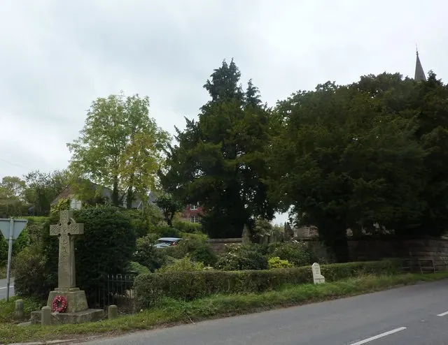 Memorial cross, milestone and churchyard